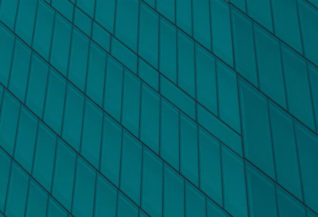 Geometric glass facade of a modern Dubai office tower